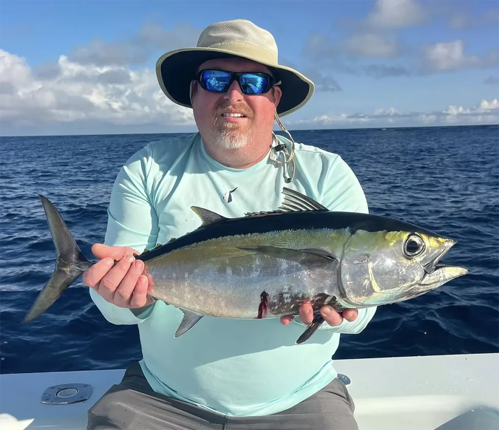 Angler holding a blackfin tuna offshore near Marathon in the Florida Keys