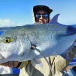 Angler holding a large blue spotted trevally on an Amami Fishing Tour in Kagoshima Japan