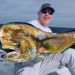 Angler holding a large dorado mahi mahi on a fishing boat near Cabo San Lucas