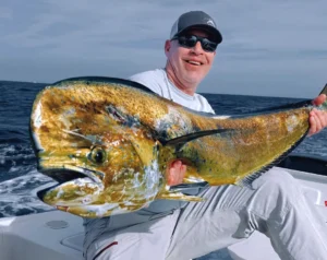 Angler holding a large dorado mahi mahi on a fishing boat near Cabo San Lucas