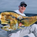 Angler holding a large dorado mahi mahi on a fishing boat near Cabo San Lucas