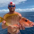Angler holding a large snapper in offshore Florida Keys