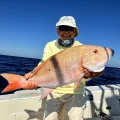 Angler holding a mutton snapper caught offshore in Marathon Florida aboard Sundance Sportfishing fishing charter