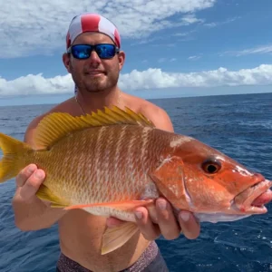 Angler holding a large snapper in offshore Florida Keys