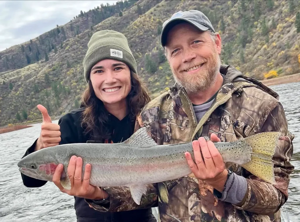 Two anglers holding a freshly caught Idaho steelhead during a November trip