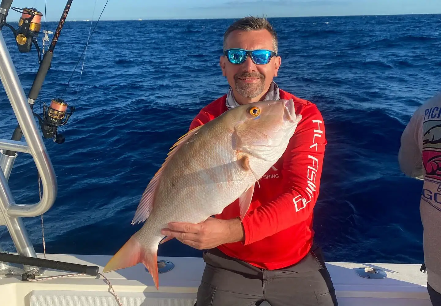Angler in Islamorada holding a large mutton snapper on a boat