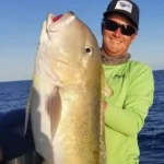 Angler holding a large golden tilefish during an offshore deep drop trip in Key Largo