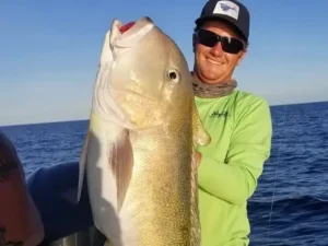 Angler holding a large golden tilefish during an offshore deep drop trip in Key Largo