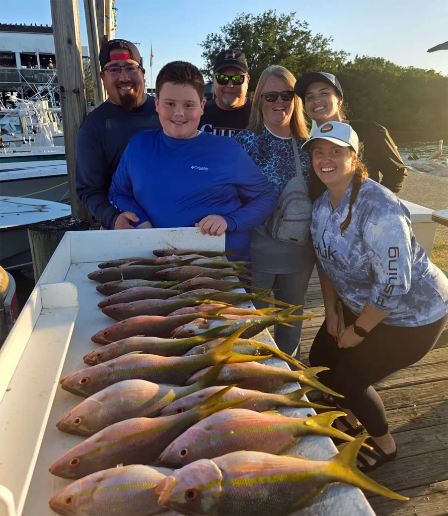Group of anglers with yellowtail snapper caught in Marathon Florida aboard Manic Sportfishing fishing charter