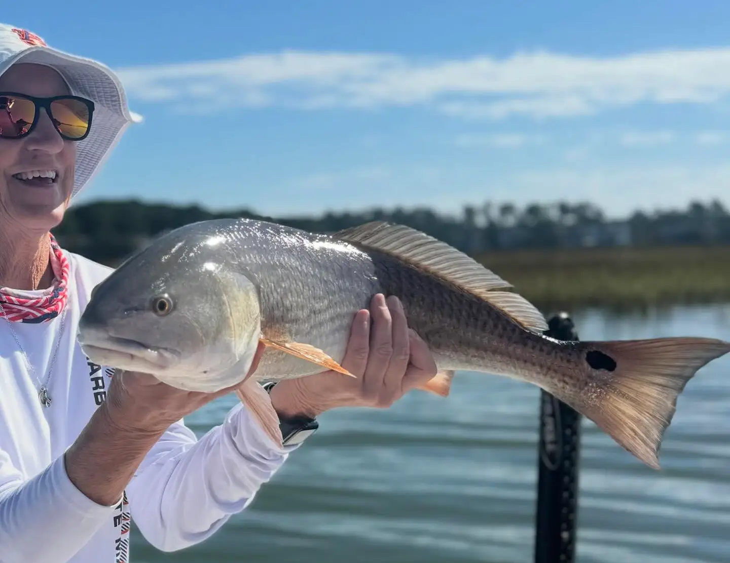 Angler holding a large redfish in Hilton Head SC during a November trip with Off the Hook Charters