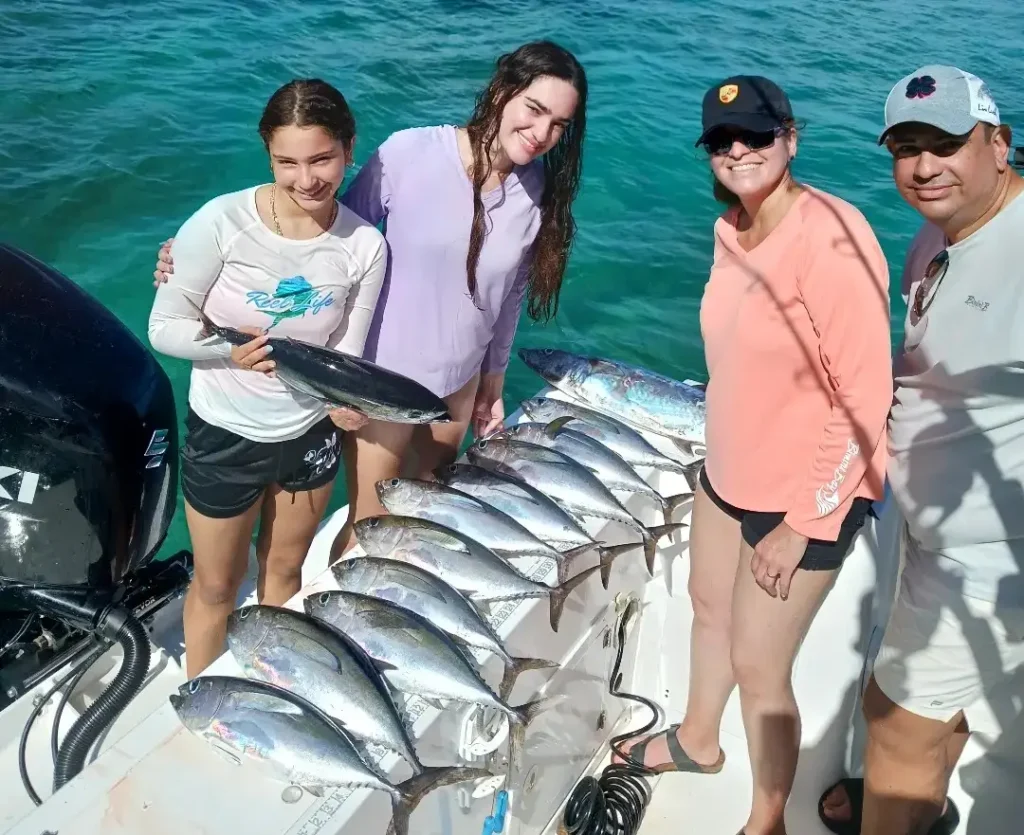 Angler holding a large yellowfin tuna caught offshore Aguadilla Puerto Rico with Salty Rod Fishing