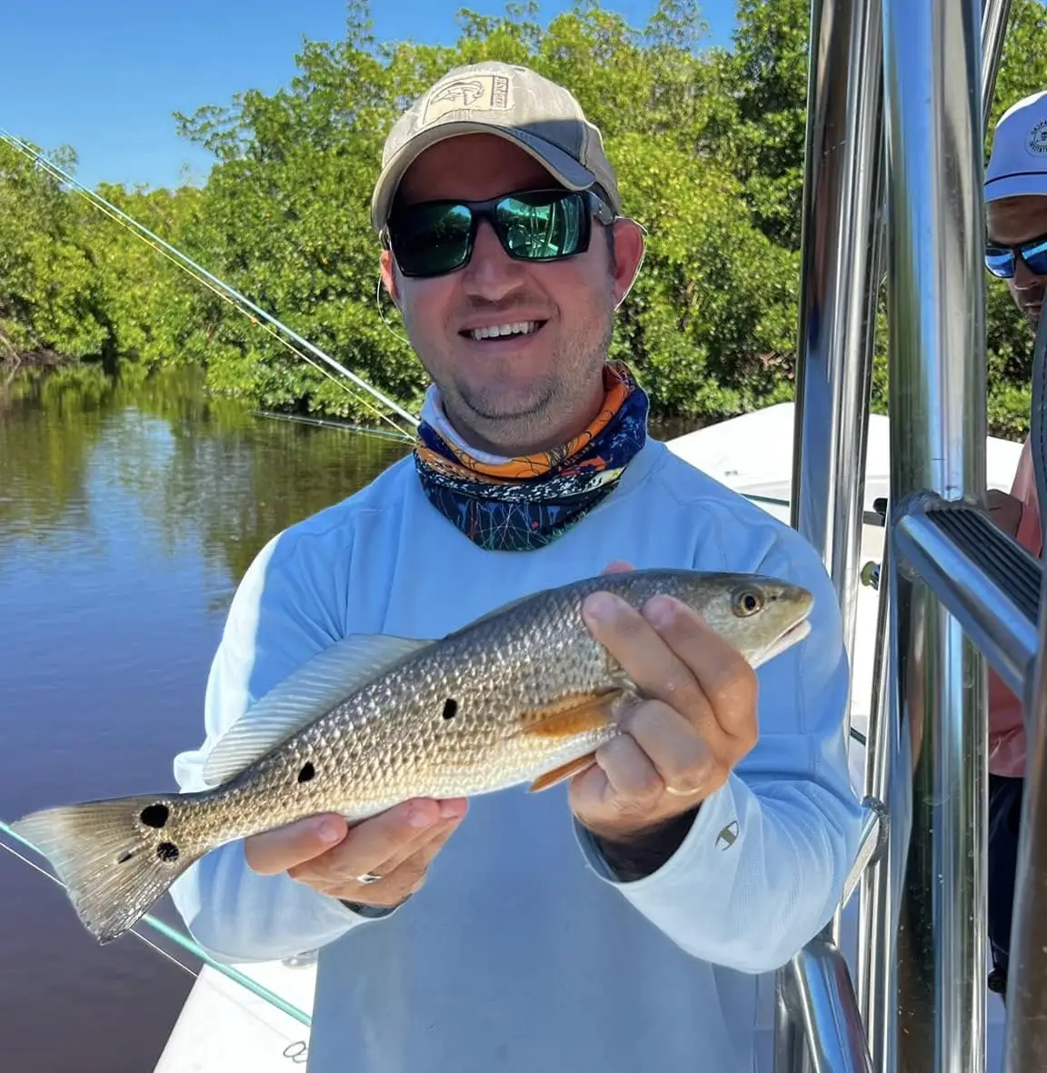 Angler holding a redfish caught in Tampa Bay Florida aboard Shallow Point Charters inshore fishing charter