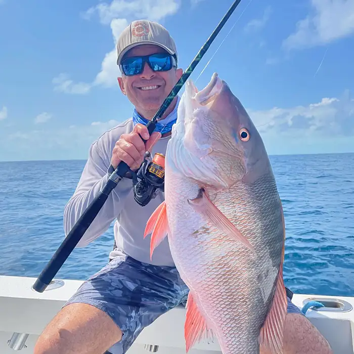Angler holding a large snapper while offshore fishing in Tavernier Florida Keys