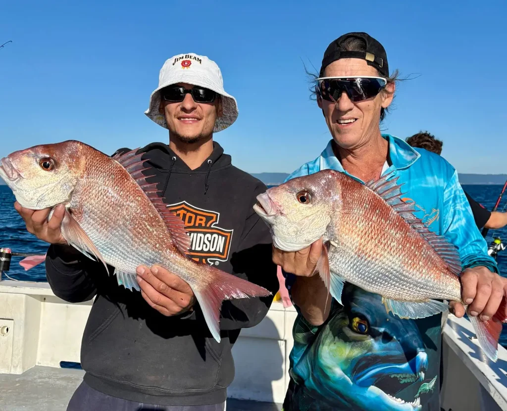 Anglers holding Australian snapper offshore Wollongong NSW in December